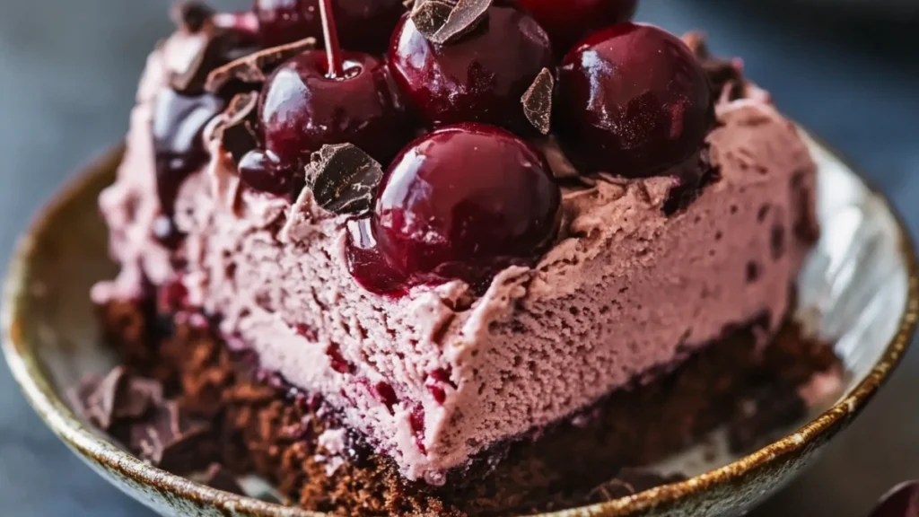 Homemade chocolate ice cream in a bowl topped with chocolate shavings.