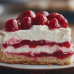 Close-up of sliced strawberry eclair cake showcasing its layered graham cracker and strawberry filling.